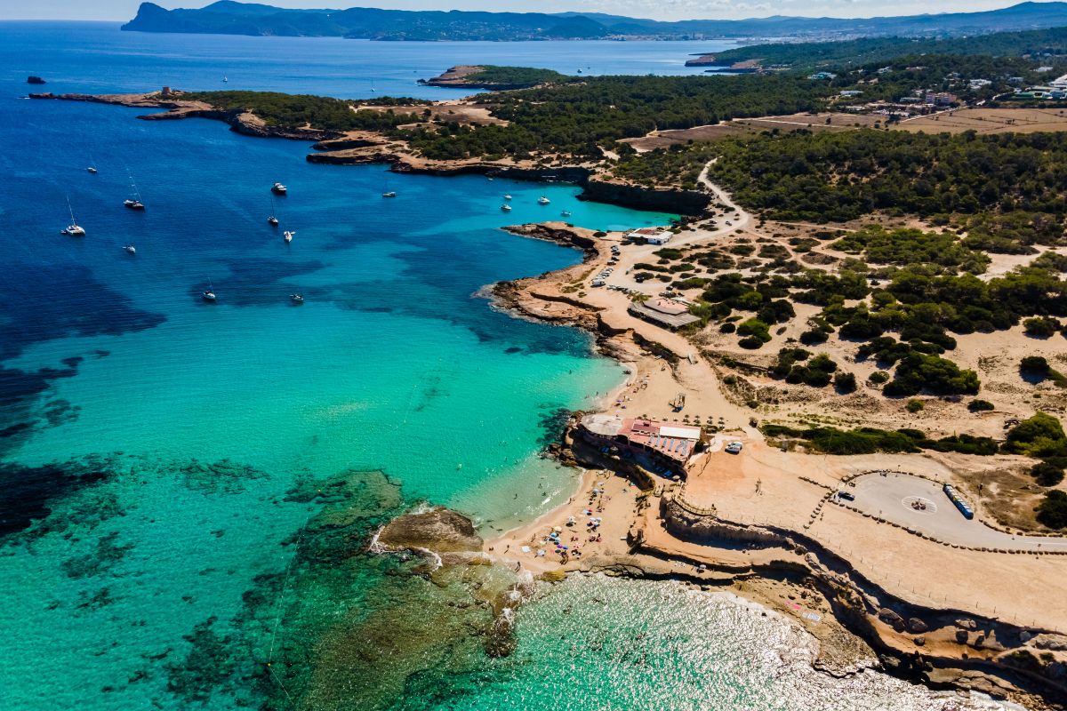 Aerial view of a coastal area with turquoise waters and sandy beaches.