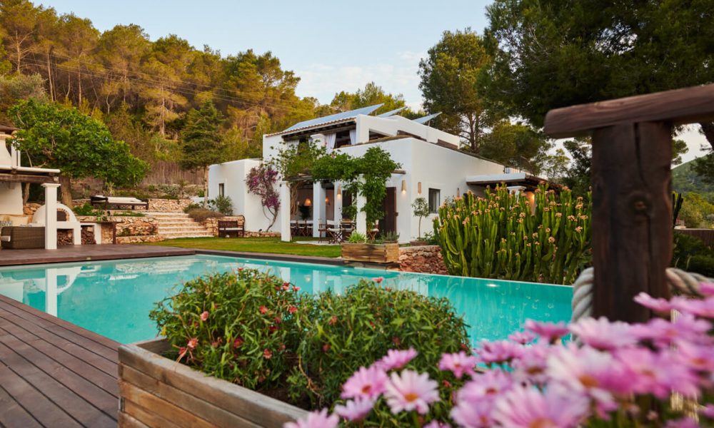 Elegant villa with pool and garden surrounded by lush greenery and flowers